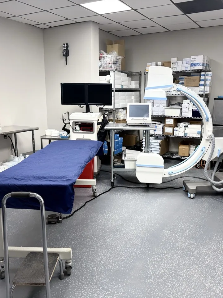 The image-guided procedure room, with the fluoroscopy arm over the table.